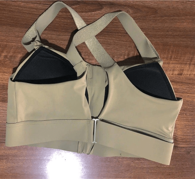 Stylish Women's Shockproof Sports Bra with Adjustable Fastening, shown on a wooden surface, offering comfort and support for fitness.